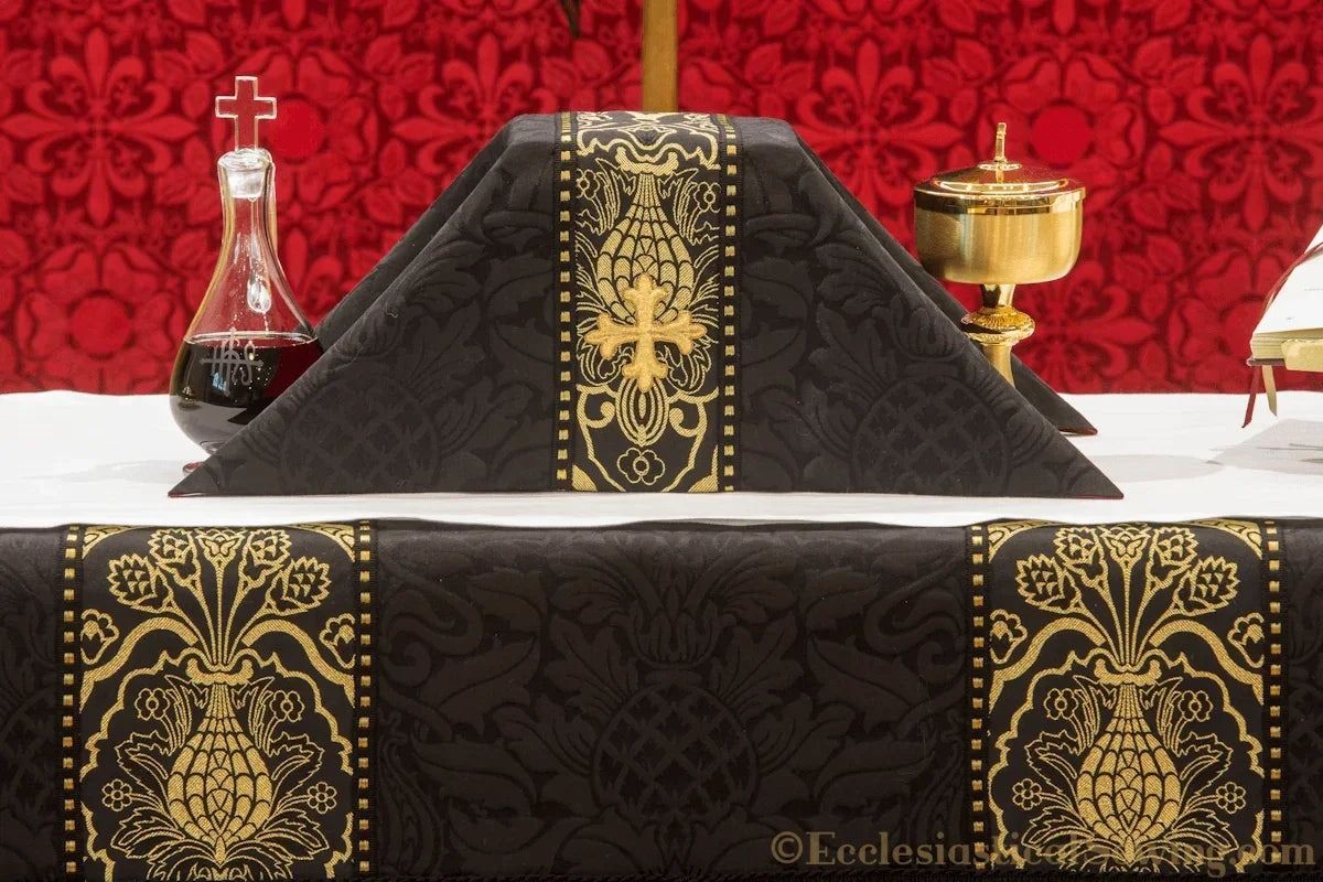 The Saint Justin Martyr chalice veil in black and gold brocade, on an altar