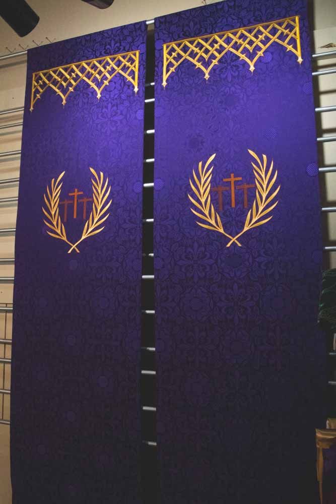 Two violet banners with palm-wreathed crosses beneath gold lattice