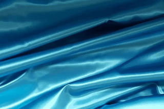 Eminence Satin fabric smooth finish close up. Polyester Satin Bridal Fabric. Used for church vestment lining. 