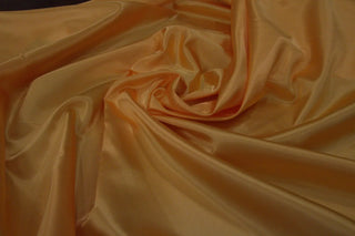 Eminence Satin fabric smooth finish close up. Polyester Satin Bridal Fabric. Used for church vestment lining. 