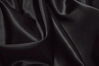 Eminence Satin fabric smooth finish close up. Polyester Satin Bridal Fabric. Used for church vestment lining. 
