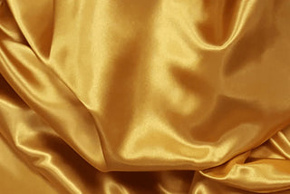 Eminence Satin fabric smooth finish close up. Polyester Satin Bridal Fabric. Used for church vestment lining. 