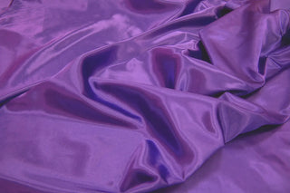 Eminence Satin fabric smooth finish close up. Polyester Satin Bridal Fabric. Used for church vestment lining. 