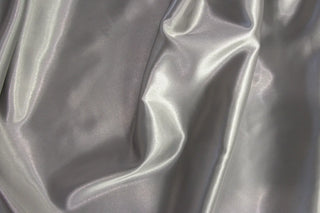Eminence Satin fabric smooth finish close up. Polyester Satin Bridal Fabric. Used for church vestment lining. 