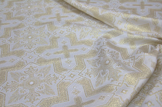 White and gold ecclesiastical brocade with eight-pointed stars, crosses, eagles and palmette motifs