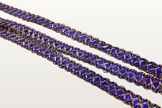Violet and gold crossover braid trim showing gold metallic X crossings over a violet ground with picot edges