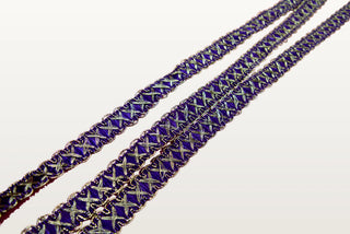 Three lengths of violet and gold crossover braid laid diagonally to show the repeat