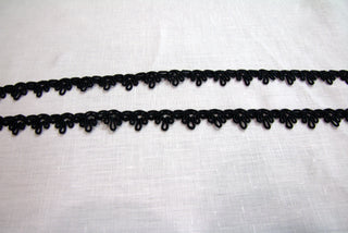 Black crown gimp braid trim showing the woven centre and open looped edges on both sides