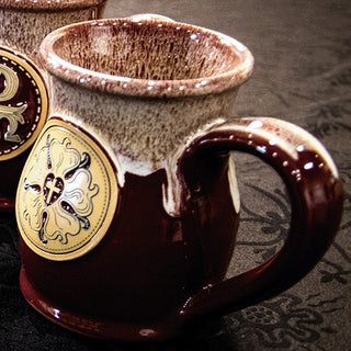 The Luther Rose Cup in Crimson Fall and Cream, showing the gold Luther Rose medallion