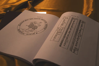 Embroidery for Church Guilds: Open pages showing an Agnus Dei emblem and decorative lettering.