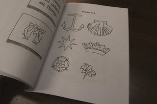 Embroidery for Church Guilds: Open pages showing an anchor, shell, star, crown, rose and lily.