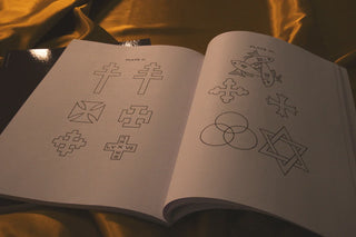 Embroidery for Church Guilds: Open pages showing cross designs and Trinity symbols.