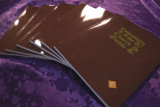 Embroidery for Church Guilds: Copies fanned across purple patterned fabric.