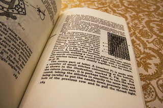 Needlework in Religion: Open pages with text and illustrations of embroidery stitches.