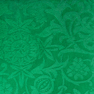Passion Flower brocade in Green with repeating woven flowers and scrolling foliage.