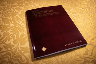 Vestments and How to Make Them: Burgundy cover resting on gold floral fabric.