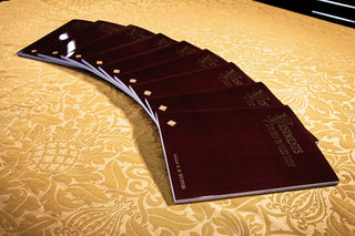 Vestments and How to Make Them: Copies fanned across gold floral fabric.