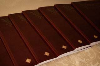 Vestments and How to Make Them: A row of burgundy covers on gold fabric.