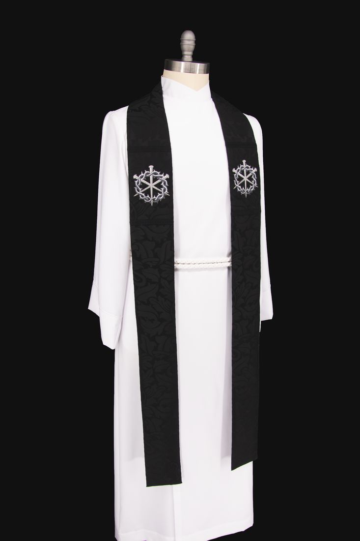 A black stole with a silver crown of thorns and three nails, on a dress form