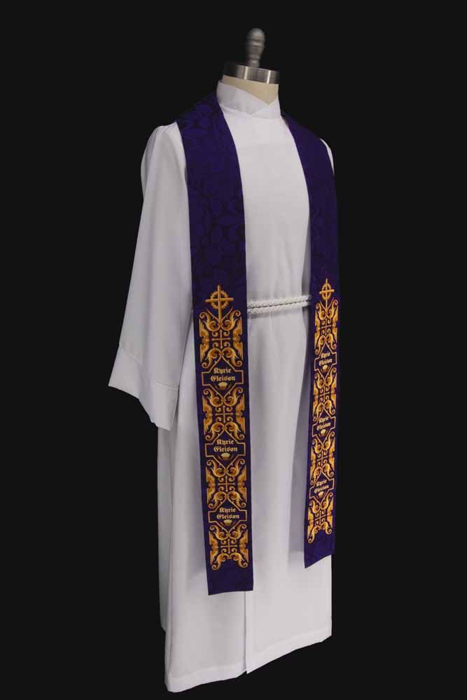 A violet stole with a cross, gold scrollwork and Kyrie Eleison, on a dress form