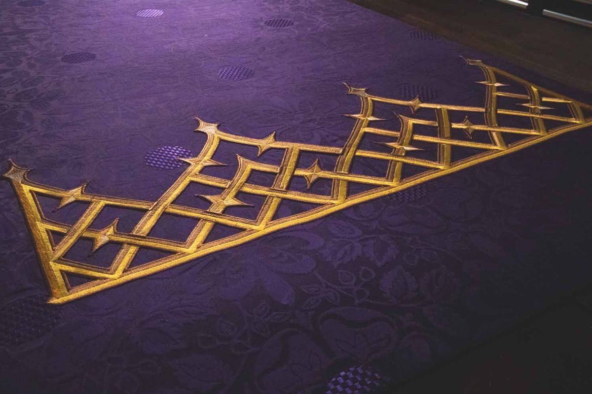 Gold lattice embroidery along the edge of a violet altar hanging
