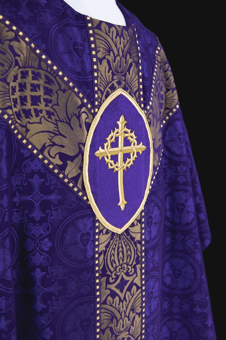 A violet chasuble with a gold cross wreathed in thorns on the orphrey