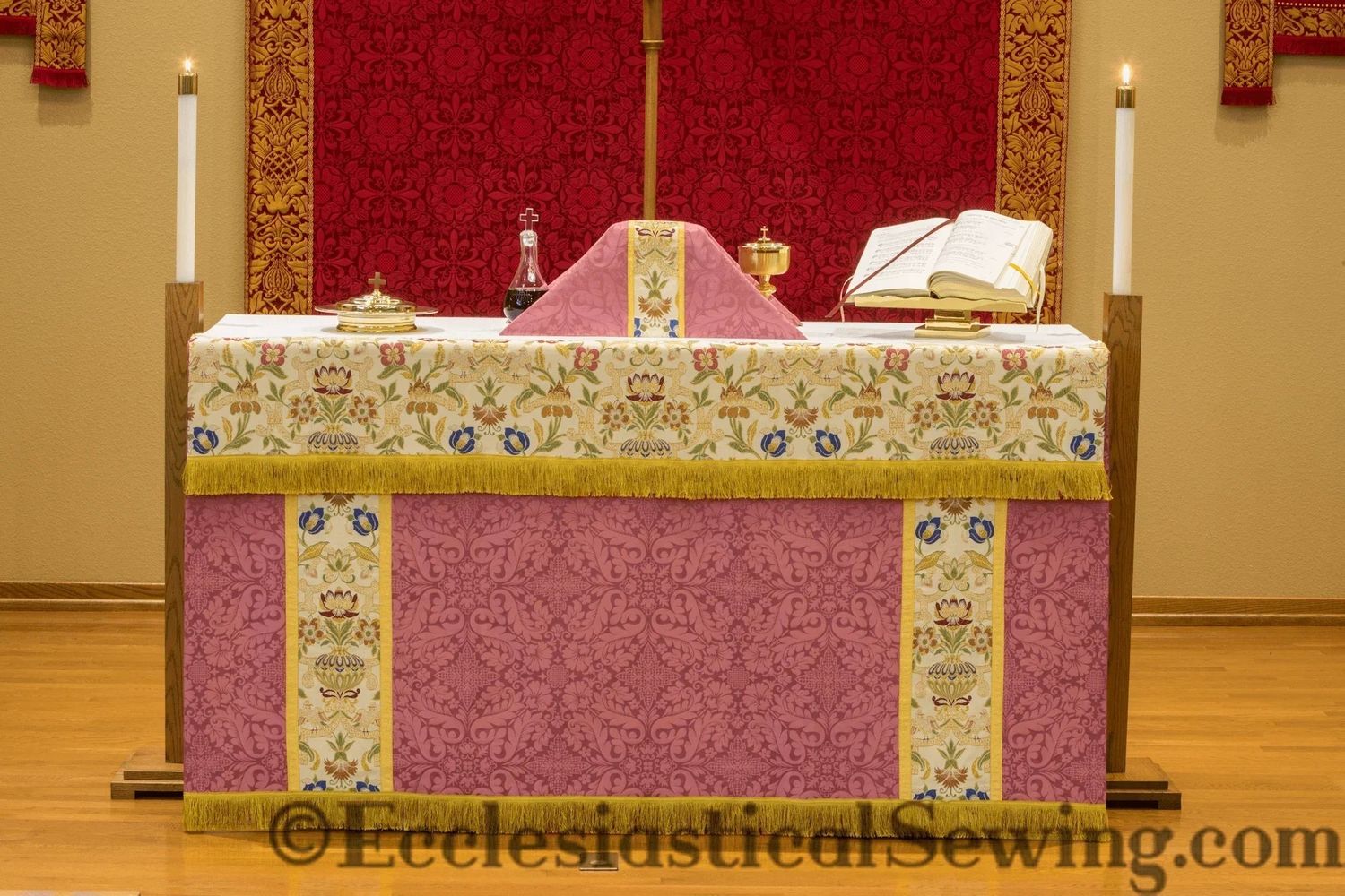 The rose Florence altar frontal with tapestry orphreys on an altar