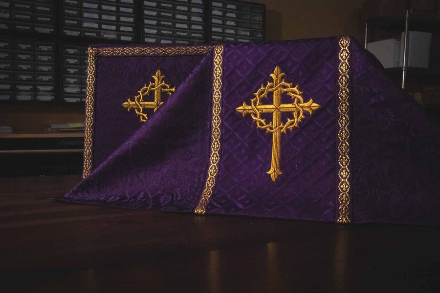 A violet hanging with two gold crosses