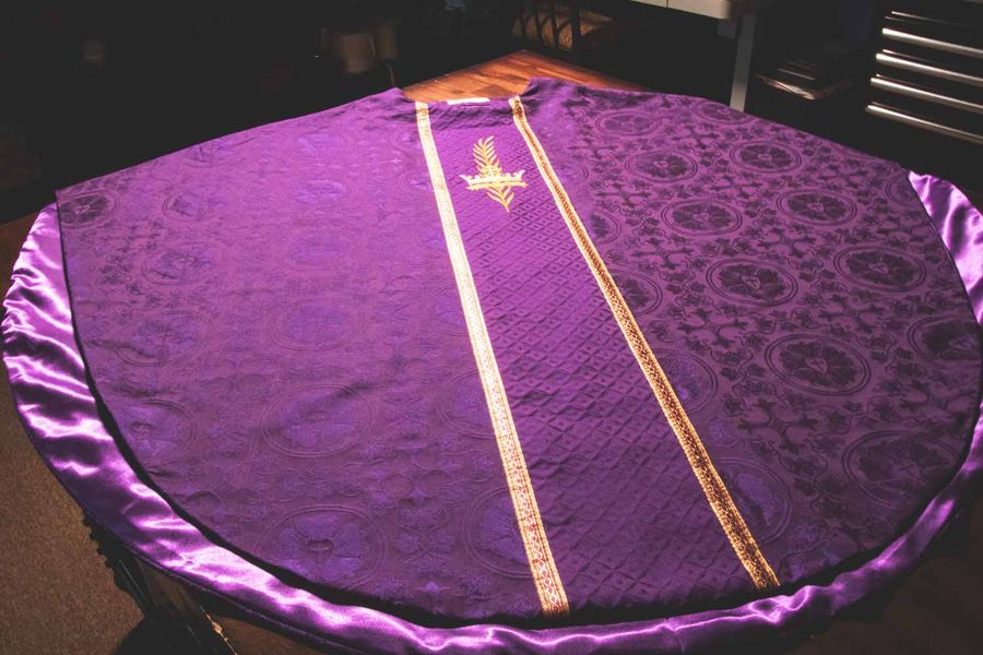 A violet chasuble laid flat on our workroom table